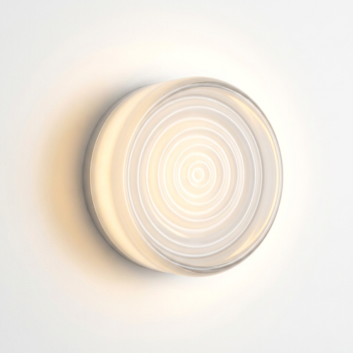 lunavera Fresnel ribbed glass wall light glowing warm white on the wall